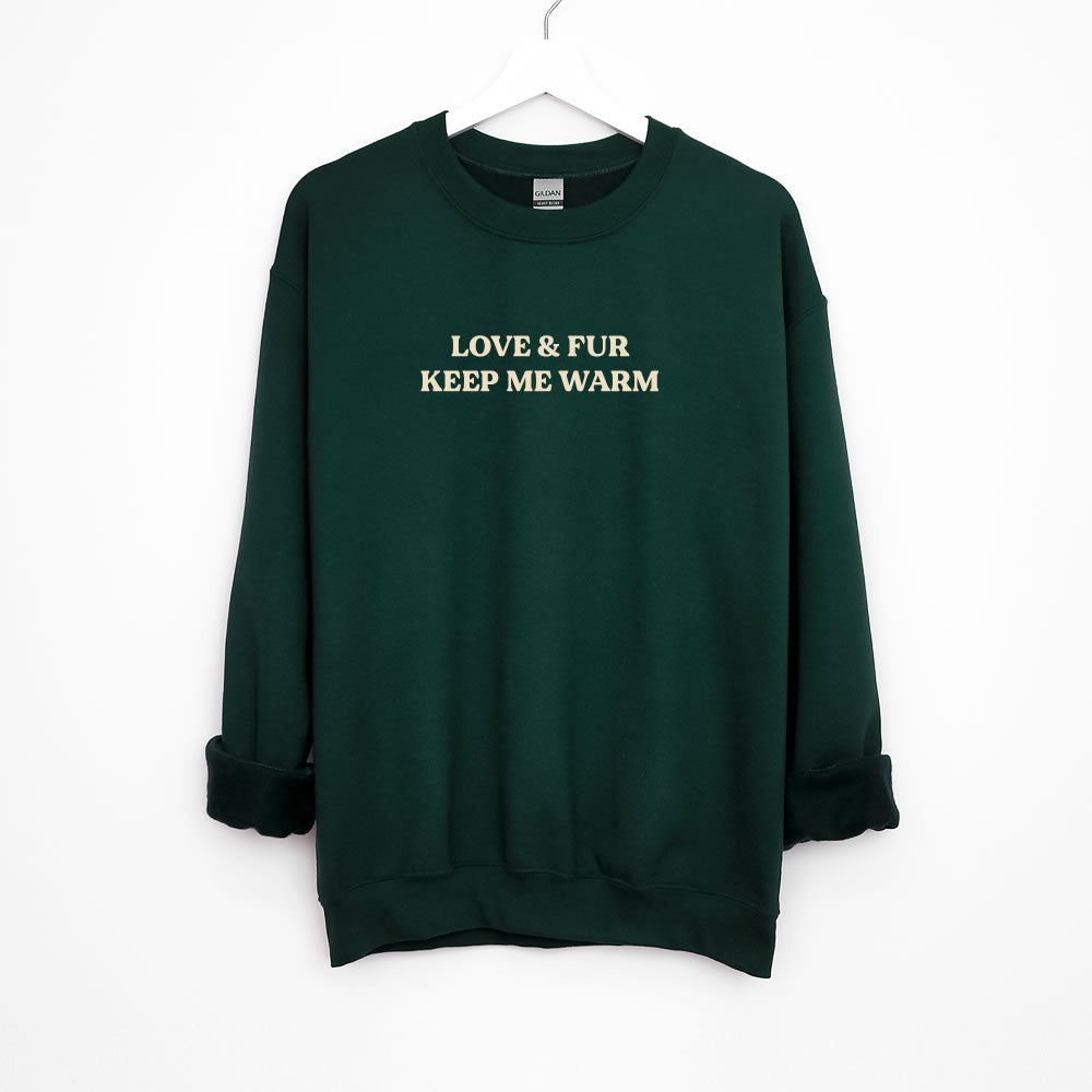 Unisex sweatshirt with text “LOVE & FUR KEEP ME WARM” — cozy crewneck pullover for dog and cat lovers.