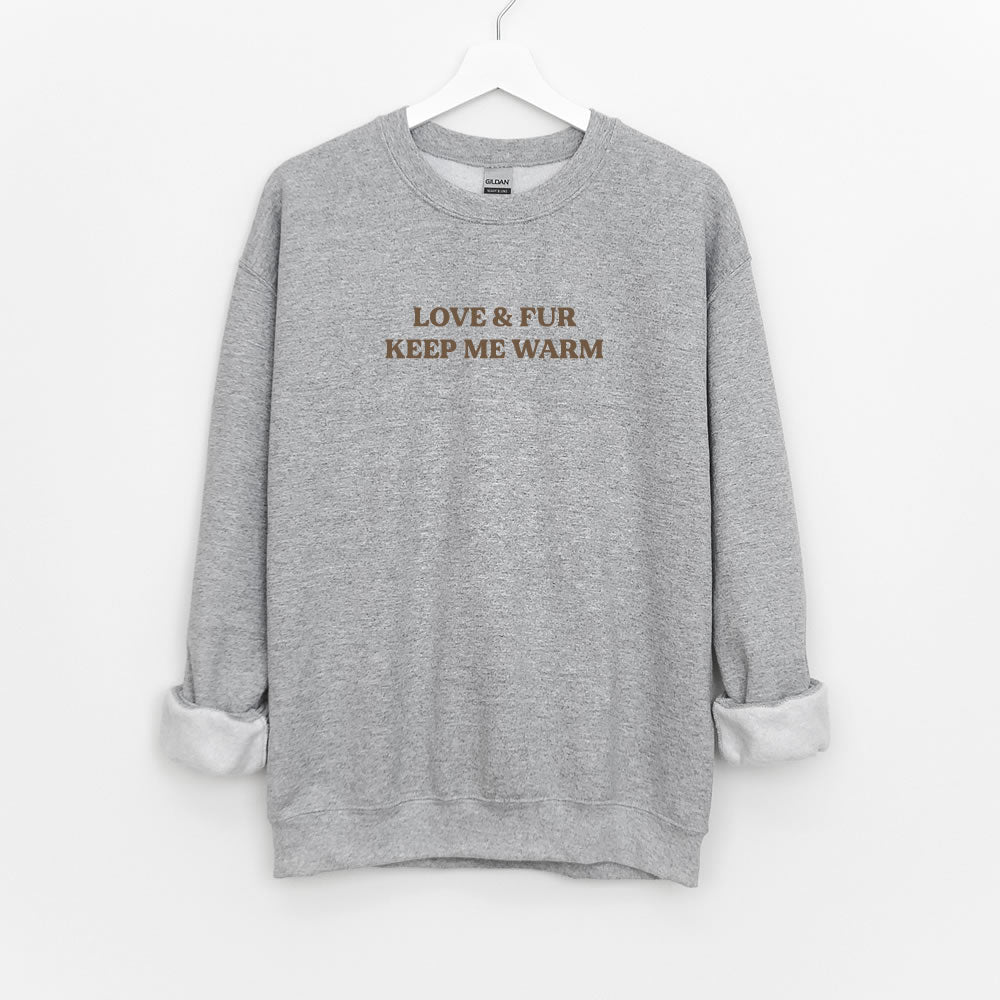 Unisex sweatshirt with text “LOVE & FUR KEEP ME WARM” — cozy crewneck pullover for dog and cat lovers.