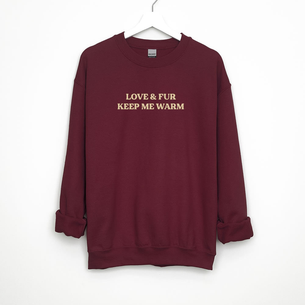 Unisex sweatshirt with text “LOVE & FUR KEEP ME WARM” — cozy crewneck pullover for dog and cat lovers.