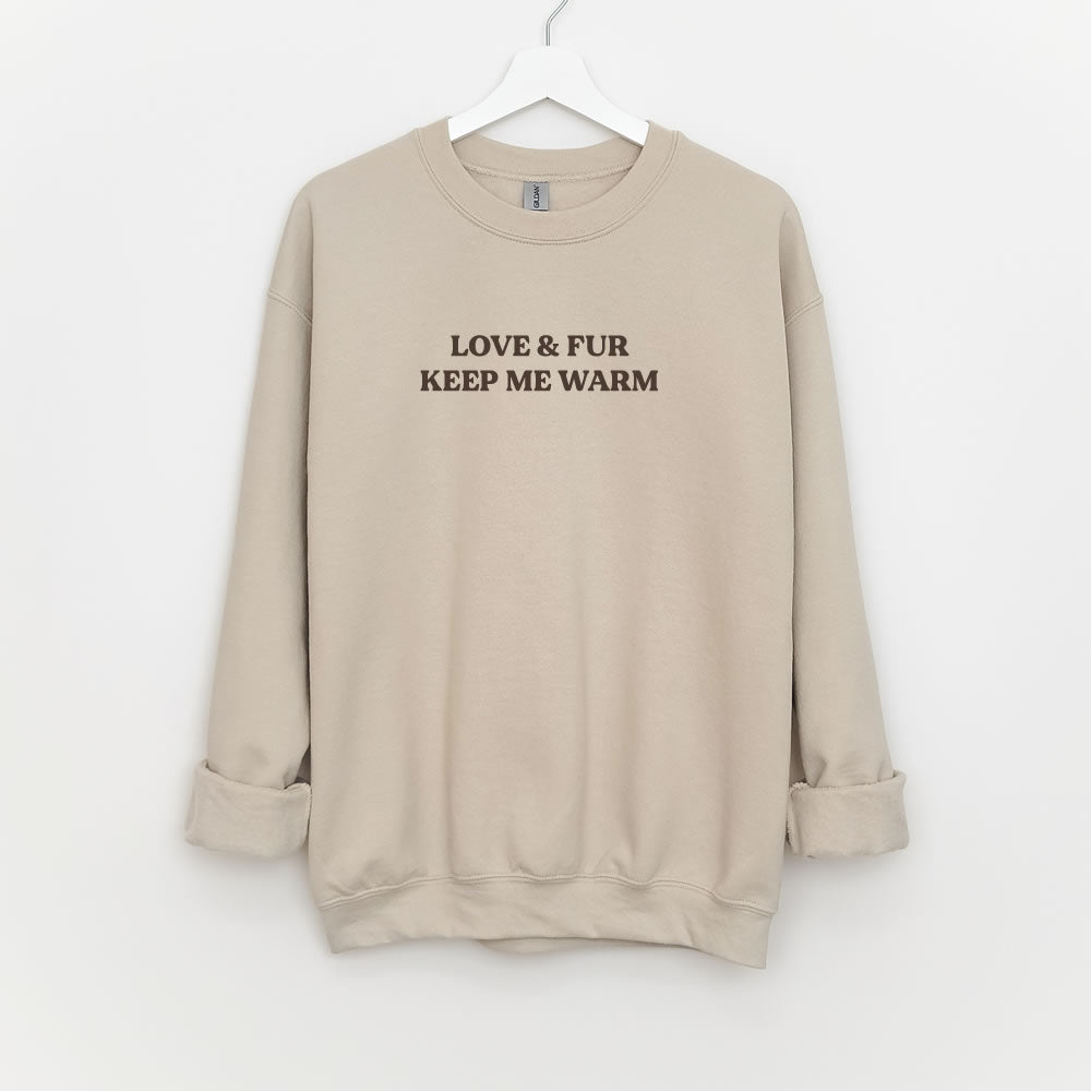 Unisex sweatshirt with text “LOVE & FUR KEEP ME WARM” — cozy crewneck pullover for dog and cat lovers.