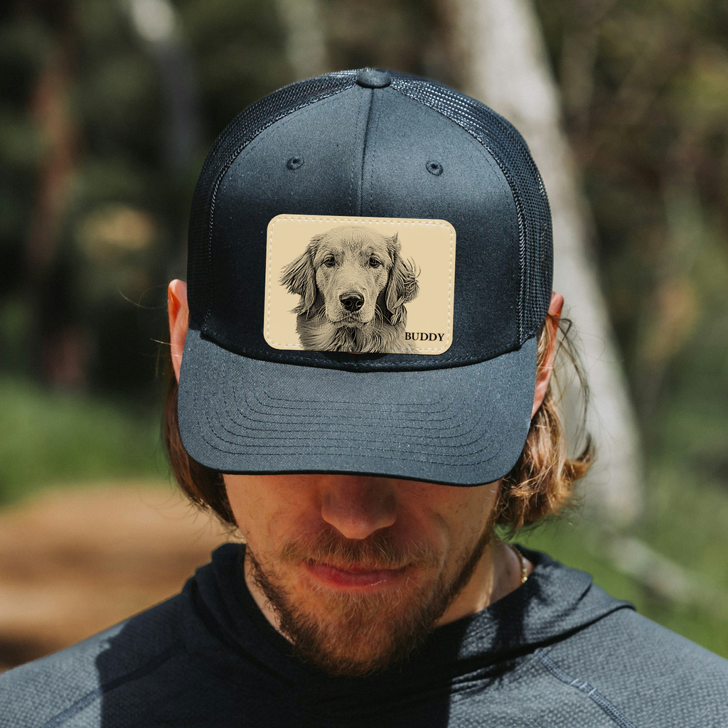 Man wearing a blue cap with a dog illustration and name 'Buddy' outdoors.