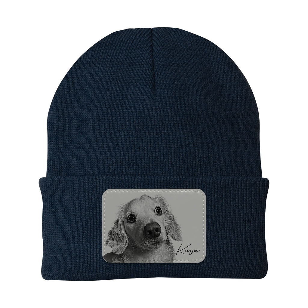 Navy blue beanie with a patch of a dog's face and name on a white background