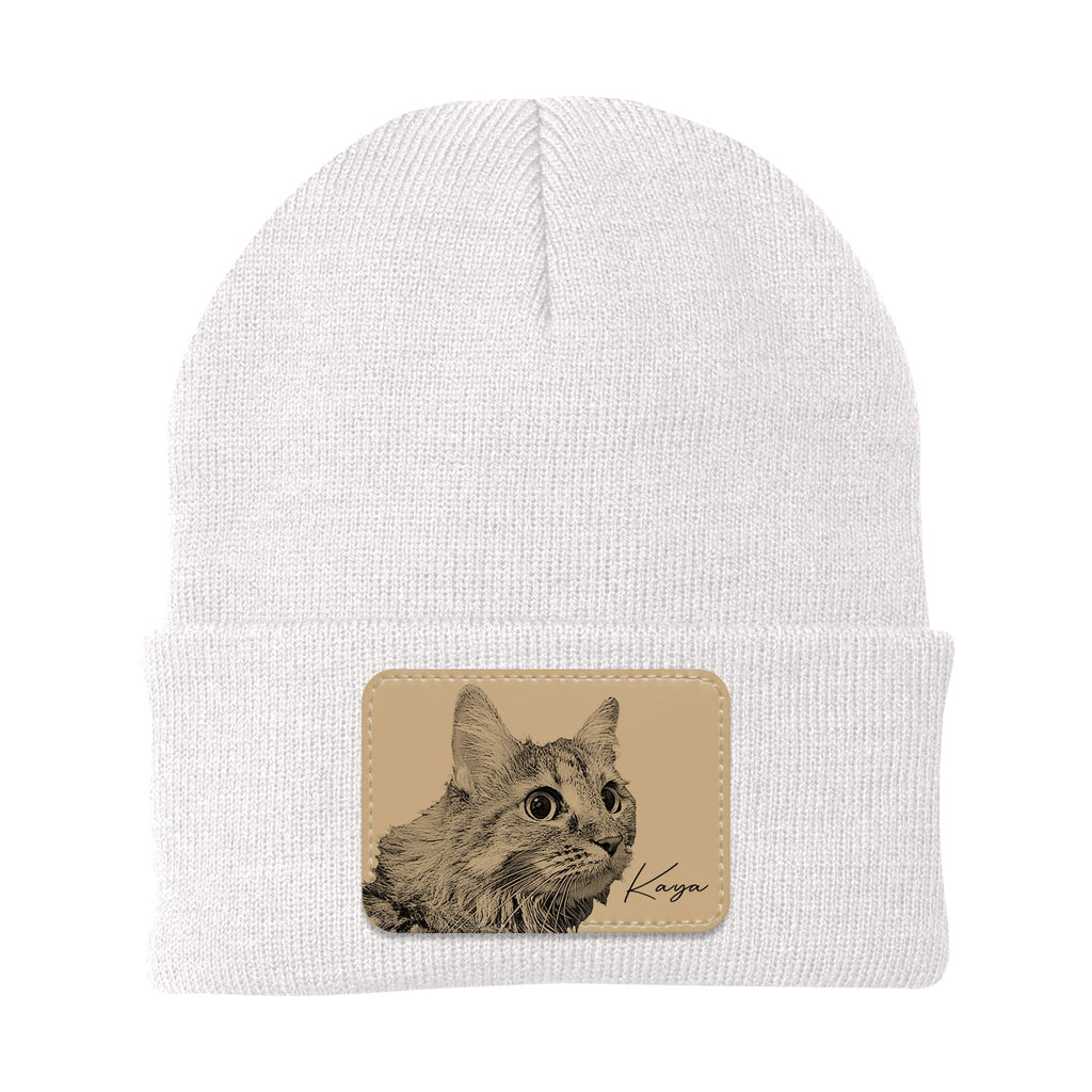 White beanie with a cat patch featuring the name 'Kaya' on a white background