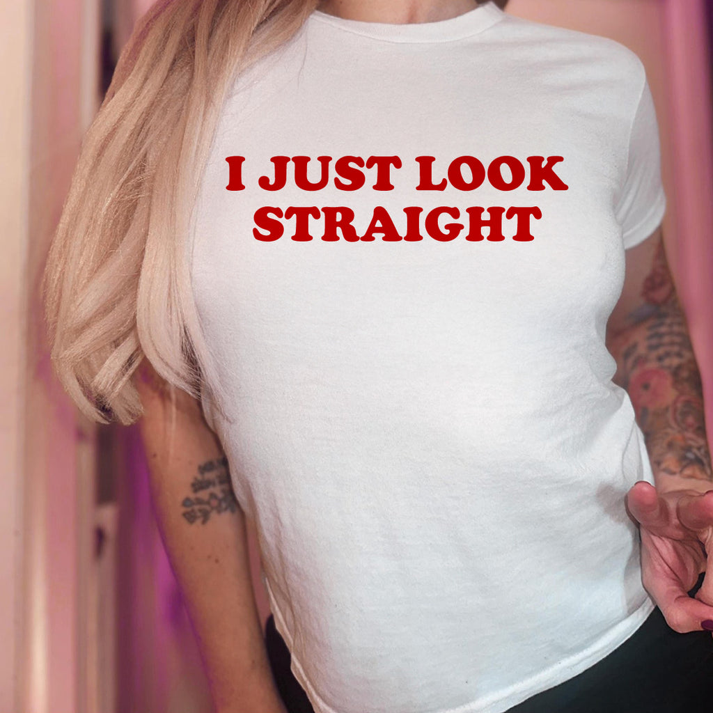 White t-shirt with red text 'I JUST LOOK STRAIGHT' worn by a person.