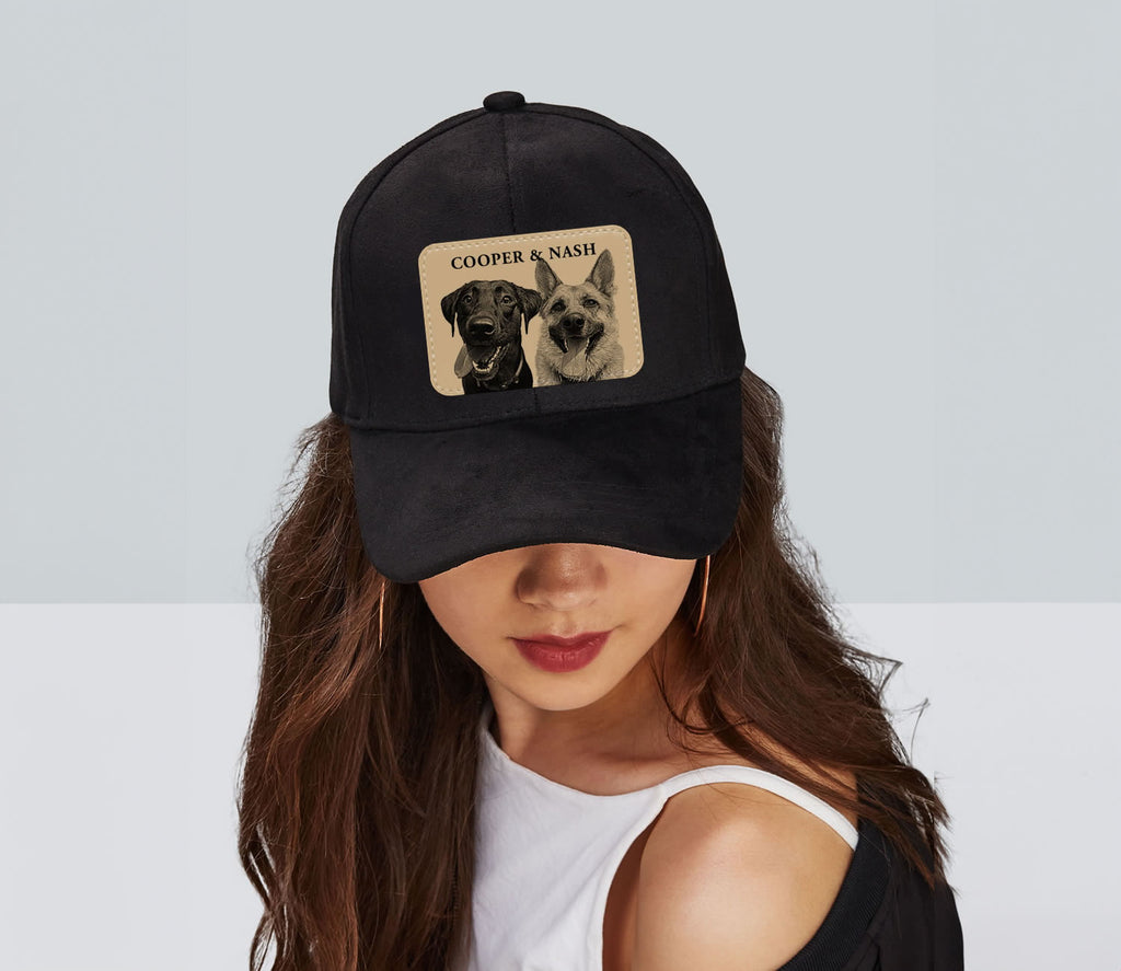 Black cap with dog pictures and text worn by a person on a light gray background