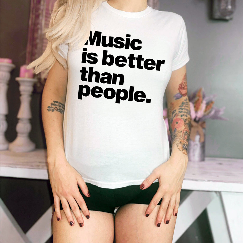 Person wearing a white t-shirt with 'Music is better than people' text.