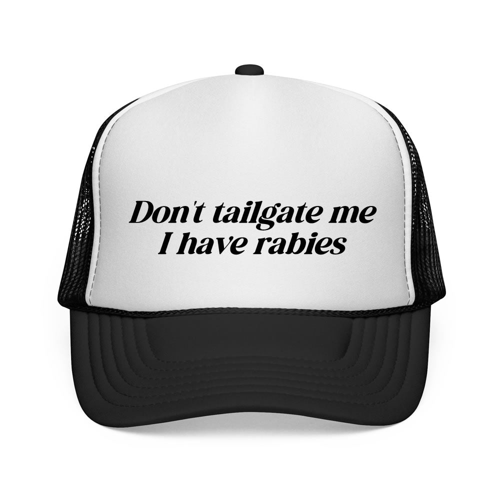 Black and white trucker hat with text 'Don't tailgate me I have rabies' on a white background