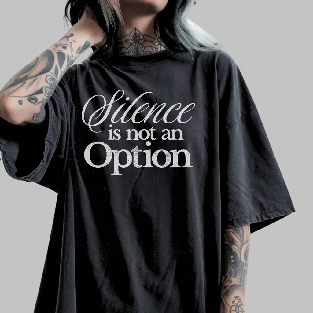Person wearing a Black t-shirt with 'Silence is not an Option' text on a gray background