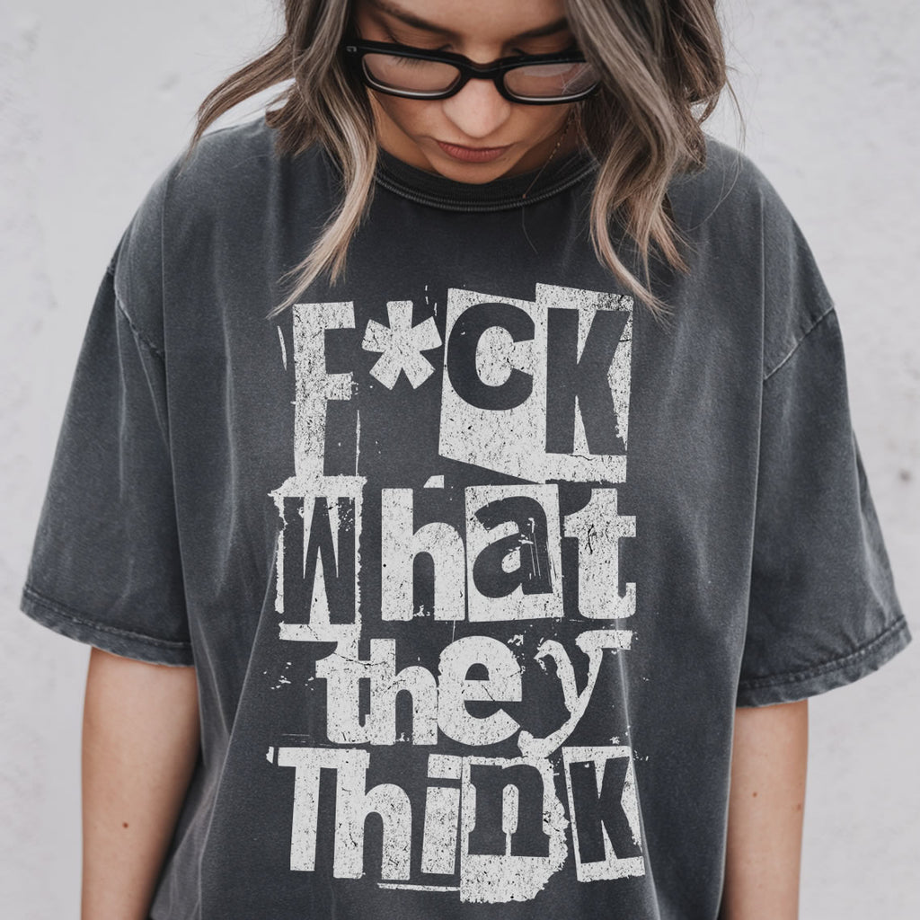 Person wearing a black t-shirt with a graphic design against a plain background