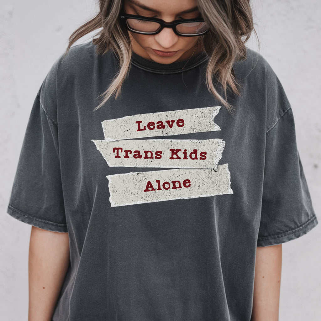 Women wearing a pepper t-shirt with 'Leave Trans Kids Alone' text.
