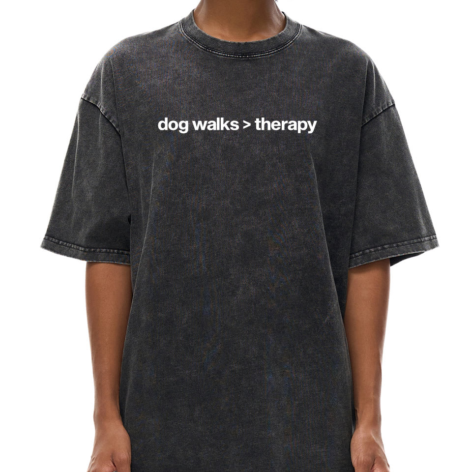 Washed black oversized cotton t‑shirt with drop shoulder design and white text “dog walks > therapy” — unisex funny dog lover graphic tee.
